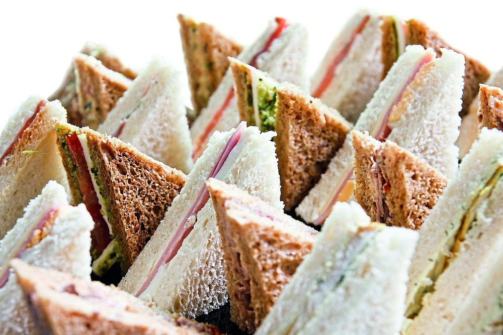 Cut platter of mixed  sandwich triangles