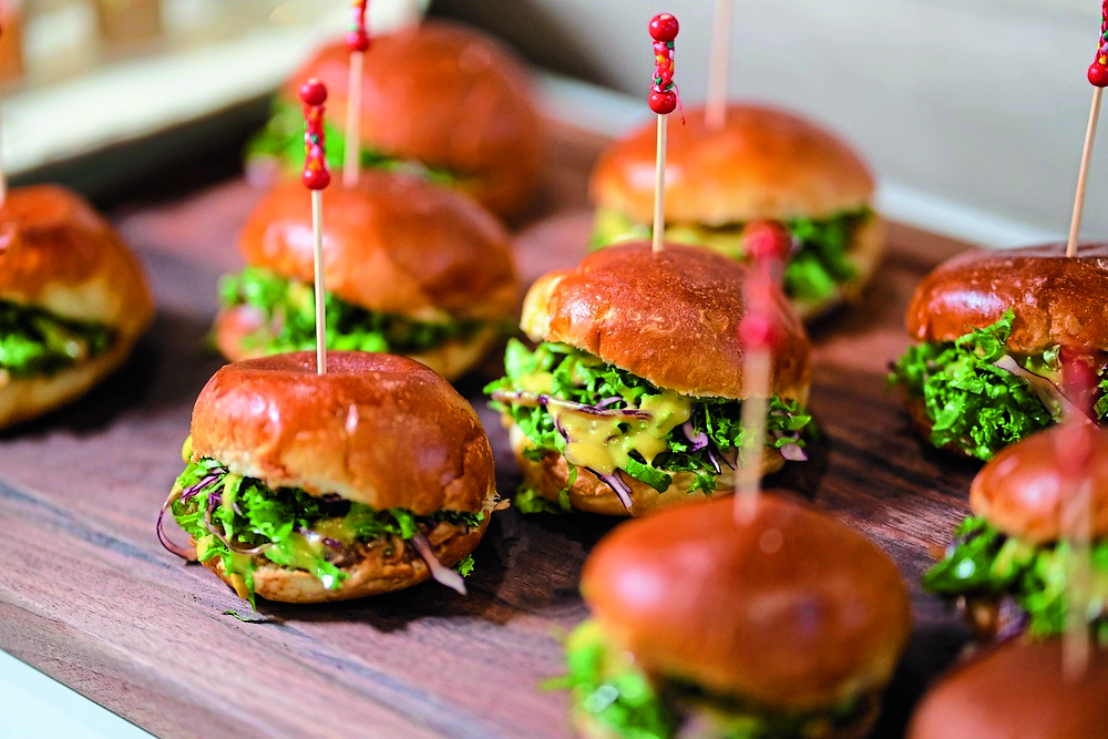 Close up mini hamburgers at cocktail party.